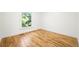 Empty bedroom showcases pristine hardwood floors and one large window, offering a blank canvas for personalization at 734 N Downing St, Denver, CO 80218