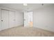 A bedroom with neutral carpet, and a closet with a door open to the hallway at 734 N Downing St, Denver, CO 80218