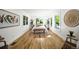 Bright bedroom features hardwood floors, three windows, and minimalist decor, creating a serene and inviting atmosphere at 734 N Downing St, Denver, CO 80218