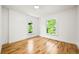 Empty bedroom shows bright light from two windows illuminating hardwood floors and providing plenty of space at 734 N Downing St, Denver, CO 80218