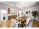 Modern dining room open to the kitchen with hardwood floors and a contemporary light fixture at 734 N Downing St, Denver, CO 80218