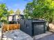 Rear exterior showing a garage, fenced yard, and 2-story home at 734 N Downing St, Denver, CO 80218