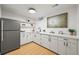 Bright kitchenette features white cabinetry, modern appliances, and ample counter space at 734 N Downing St, Denver, CO 80218