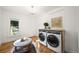 Bright laundry room with modern washer and dryer, chandelier, and window at 734 N Downing St, Denver, CO 80218