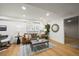 Finished basement living room features hardwood floors, a brown sofa, and ample lighting at 734 N Downing St, Denver, CO 80218