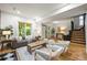 Spacious living area with ample seating, hardwood floors, and bright natural light at 734 N Downing St, Denver, CO 80218