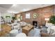 Inviting living room with a brick fireplace, hardwood floors, and an open layout at 734 N Downing St, Denver, CO 80218