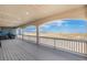 A spacious back porch with an idyllic view of the surrounding open landscape at 1222 S County Road 185, Byers, CO 80103