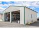 Barn featuring a large open bay and corrugated metal siding at 1222 S County Road 185, Byers, CO 80103