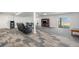 Spacious finished basement with comfortable black recliners and a walkout to the backyard at 1222 S County Road 185, Byers, CO 80103
