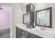 Bathroom featuring double sinks with modern faucets and a tall cabinet for storage at 1222 S County Road 185, Byers, CO 80103