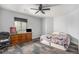 Bedroom with a ceiling fan, a wooden dresser, and a queen bed at 1222 S County Road 185, Byers, CO 80103