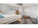 Bedroom with a ceiling fan, a dresser, and two beds at 1222 S County Road 185, Byers, CO 80103