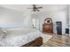 Spacious bedroom with wood floors and a ceiling fan at 1222 S County Road 185, Byers, CO 80103