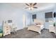 Bright bedroom with a ceiling fan, a desk, and a white bed frame at 1222 S County Road 185, Byers, CO 80103