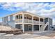 Blue home featuring a large back porch and a partially finished yard at 1222 S County Road 185, Byers, CO 80103