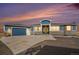 Beautiful blue two-story home with stone accents, three car garage, and a concrete driveway at 1222 S County Road 185, Byers, CO 80103