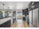 Open-concept kitchen with a large island, stainless steel appliances, and a view of the outdoor patio at 1222 S County Road 185, Byers, CO 80103