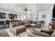 Spacious living room area with gray walls, wood flooring, and a plush sectional sofa at 1222 S County Road 185, Byers, CO 80103