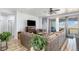 Cozy living room with wood-look floors, a fireplace, and a large sectional sofa near sliding glass doors at 1222 S County Road 185, Byers, CO 80103