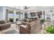 Open living space with wood floors, a comfortable sectional, and access to the outdoor patio at 1222 S County Road 185, Byers, CO 80103