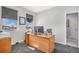 Bright home office featuring a wooden desk and two windows at 1222 S County Road 185, Byers, CO 80103