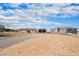 Wide view of a property including a home, a barn, and a partially graveled yard at 1222 S County Road 185, Byers, CO 80103