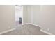 Bedroom with gray carpet flooring, white trim, and an open doorway leading to a space with hardwood floors at 336 E 1St Ave # 207, Denver, CO 80203