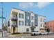 Three-story building with modern design, balconies, and street parking on a sunny day at 336 E 1St Ave # 207, Denver, CO 80203