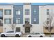 Modern apartment building with blue and white exterior, balconies, and street parking in front at 336 E 1St Ave # 207, Denver, CO 80203