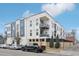 Modern apartment building with balconies and street parking on a sunny day at 336 E 1St Ave # 207, Denver, CO 80203