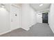 Apartment hallway with neutral carpeting and white doors at 336 E 1St Ave # 207, Denver, CO 80203