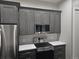 Contemporary kitchen featuring stainless steel appliances, gray cabinets, and white countertops at 336 E 1St Ave # 207, Denver, CO 80203