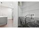 Convenient laundry room with modern washer/dryer, sink, cabinets and storage shelves at 336 E 1St Ave # 207, Denver, CO 80203