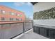 Cozy patio with glass fencing, greenery wall art, and outdoor storage chest at 336 E 1St Ave # 207, Denver, CO 80203