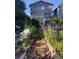 Idyllic backyard garden featuring brick pathways and lush flower beds, leading up to the home at 810 Miner St, Idaho Springs, CO 80452