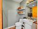 Modern bathroom featuring a stylish sink, tiled shower, and decorative shelving at 810 Miner St, Idaho Springs, CO 80452