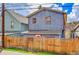 Exterior rear view of the home showing wooden fence at 810 Miner St, Idaho Springs, CO 80452