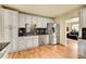 Modern kitchen featuring stainless steel appliances, granite countertops, and white cabinetry at 810 Miner St, Idaho Springs, CO 80452