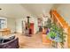 Cozy living room featuring a wood-burning stove, hardwood floors, and a staircase at 810 Miner St, Idaho Springs, CO 80452