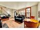 Sun-filled living room with hardwood floors, black sofa and a greenhouse-style window at 810 Miner St, Idaho Springs, CO 80452