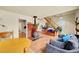 Bright living area with a wood-burning stove, hardwood floors, and staircase at 810 Miner St, Idaho Springs, CO 80452