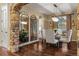 Elegant dining room featuring hardwood floors, modern lighting, and stone arch at 9797 Sunset Hill Cir, Lone Tree, CO 80124