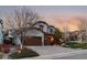 Charming two-story home with a three car garage and fresh landscaping at 9797 Sunset Hill Cir, Lone Tree, CO 80124