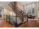 Grand foyer with high ceilings, hardwood floors, and staircase with iron railings at 9797 Sunset Hill Cir, Lone Tree, CO 80124