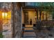 Inviting front porch with stone accents and decorative lighting at 9797 Sunset Hill Cir, Lone Tree, CO 80124