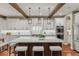 Gourmet kitchen with white cabinets, stainless steel appliances, and a large center island at 9797 Sunset Hill Cir, Lone Tree, CO 80124
