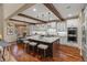 Bright kitchen with marble countertops, stainless appliances, wood beams, and hardwood floors at 9797 Sunset Hill Cir, Lone Tree, CO 80124