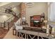 Cozy living room with stone fireplace, high ceilings, and staircase at 9797 Sunset Hill Cir, Lone Tree, CO 80124