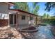 An inviting backyard features a covered patio with sliding glass door access and meticulous landscaping at 12378 E Cedar Cir, Aurora, CO 80012